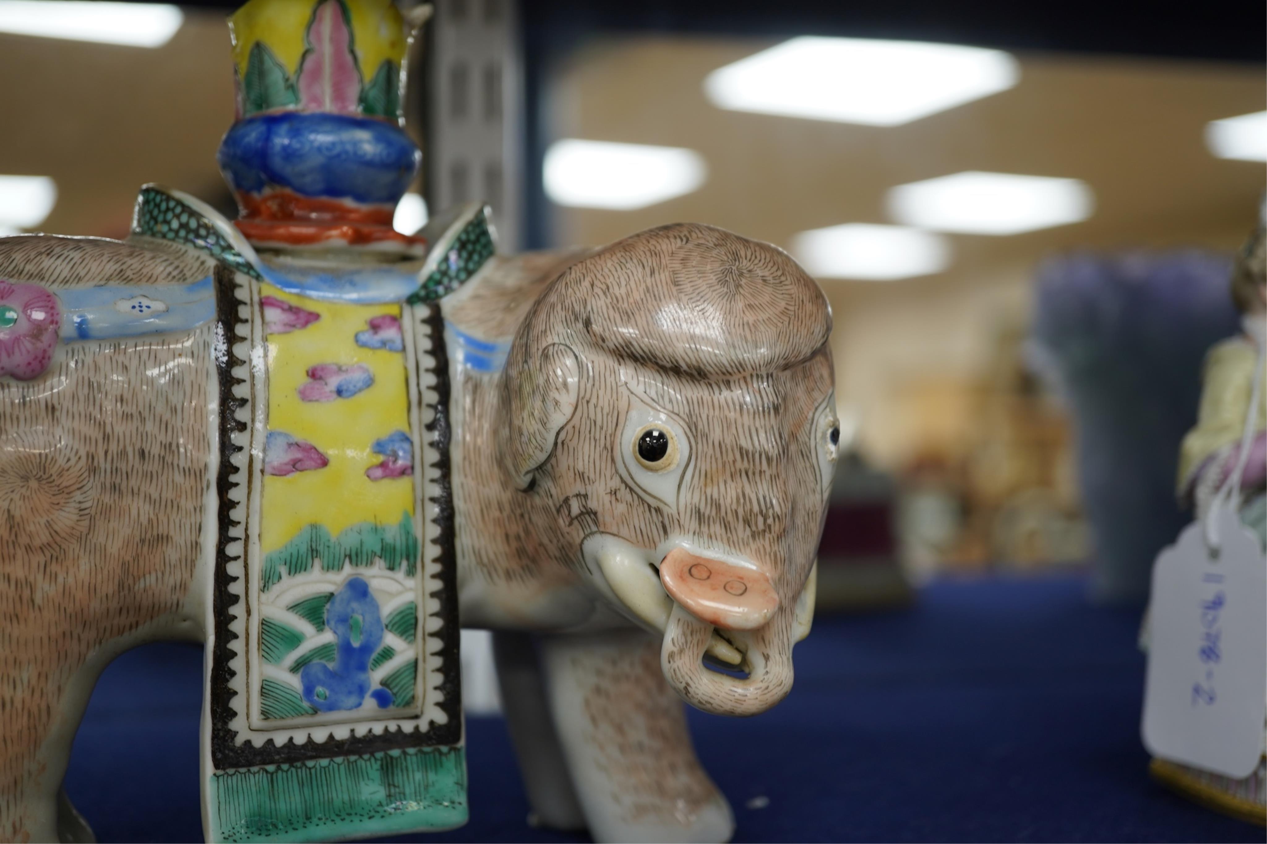 A 19th century Chinese enamelled porcelain vase in the form of an elephant with a howdah on its back